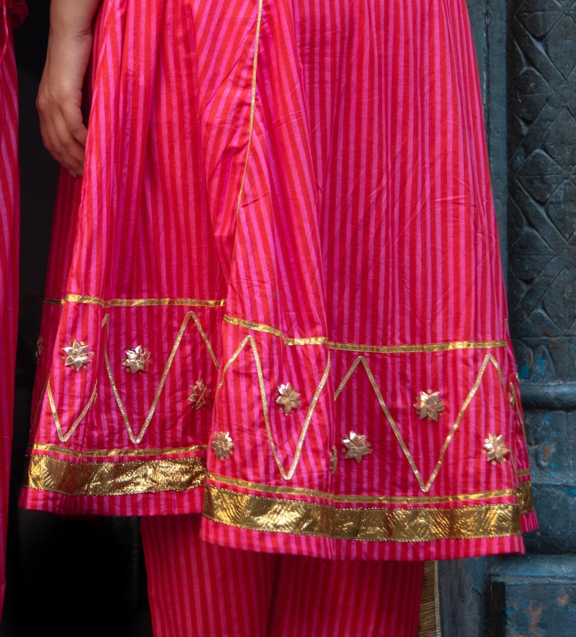 Anaaro - fuschia pink Bagdi dress in 100% striped cotton with hand embroidered gota flowers and sequins. - CiceroniDressAnaaro