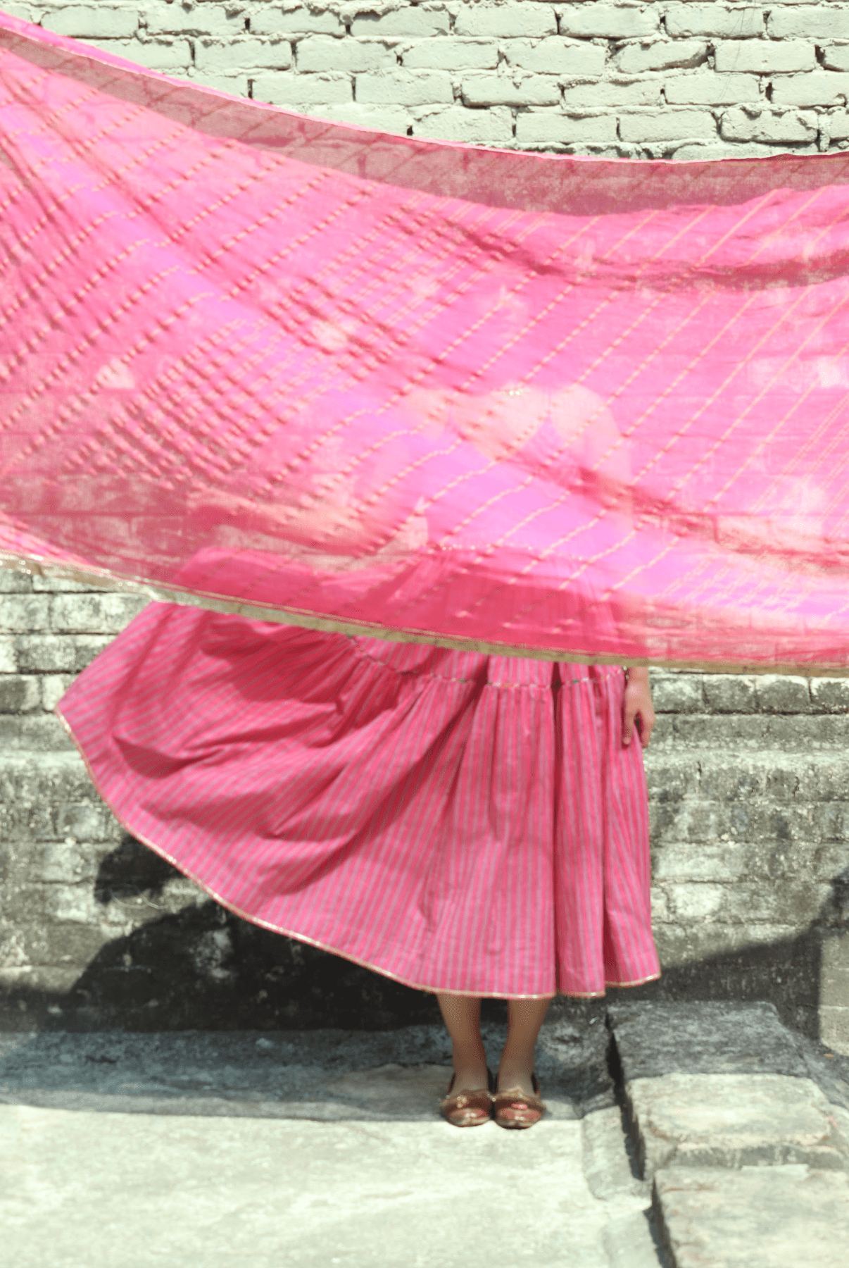 Anaaro - pink kanchli strappy dress in hand block print stripes with multicoloured piping detail - CiceroniDressAnaaro
